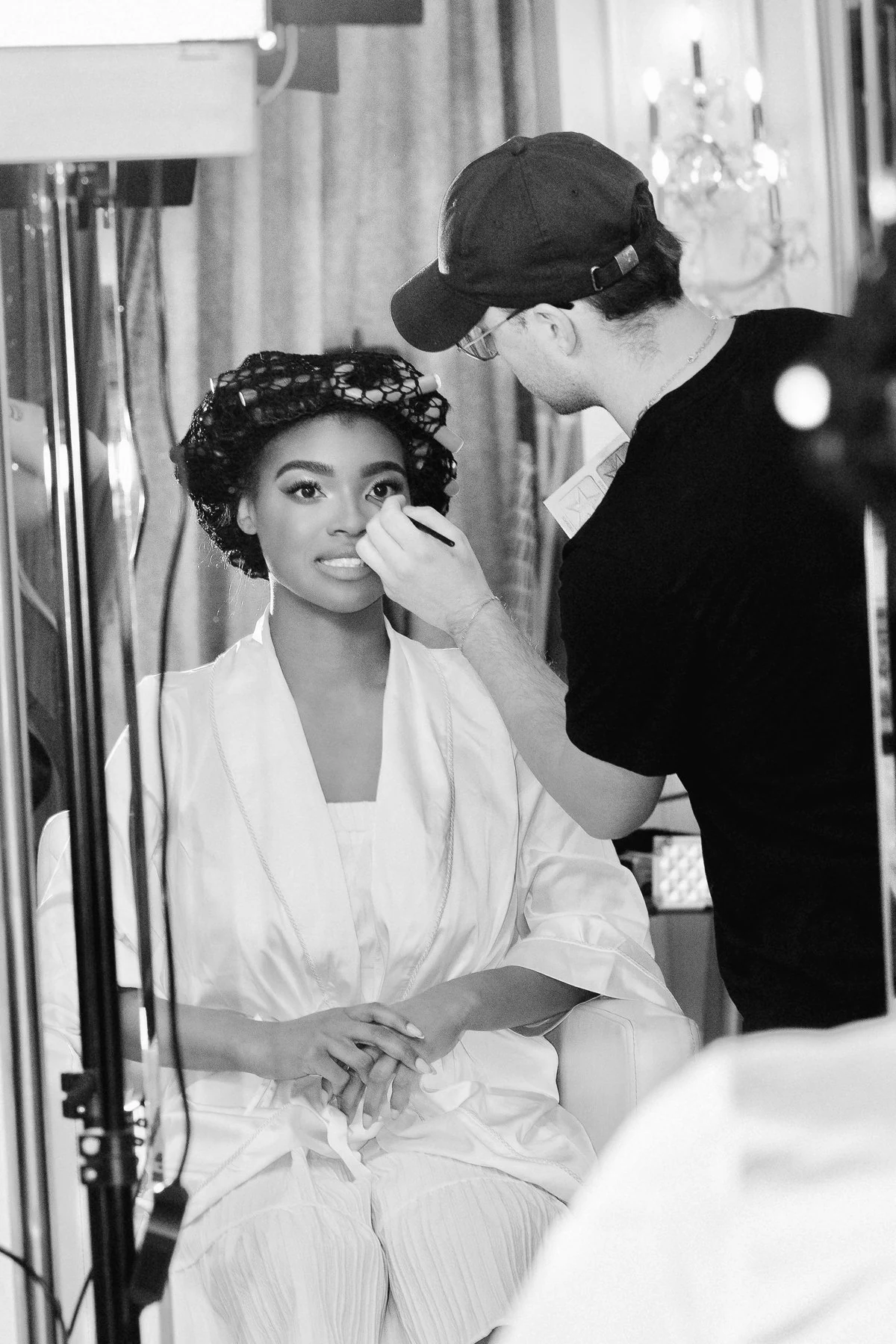 A Refined Beauty Co. artist adding the finishing touches to bridal makeup